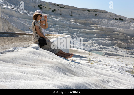 Woman at calcite terraces and sulphur water pools at Pamukalle Turkey Stock Photo