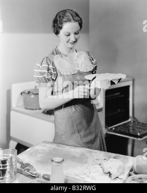 Woman preparing a pie in the kitchen Stock Photo