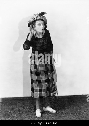 Woman in a hat trying to hear Stock Photo