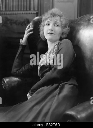 Profile of a woman sitting in an armchair Stock Photo