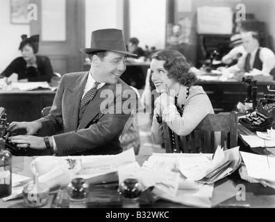 Man and woman together in the office flirting with each other Stock Photo