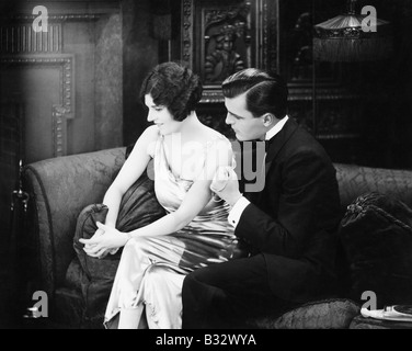 Couple sitting together on a couch Stock Photo