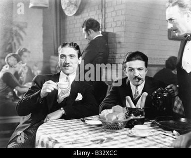 Two men sitting together at a restaurant Stock Photo