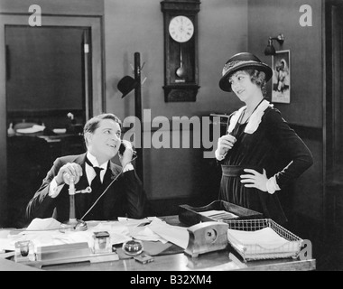 Man and woman flirting in the office Stock Photo