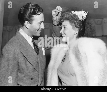 Man lifting the veil of a young woman Stock Photo