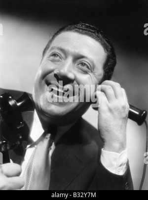 Portrait of a man on the telephone laughing and happy Stock Photo