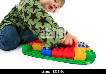 little boy playing with Lego bricks Stock Photo