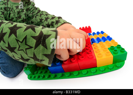 little boy playing with Lego bricks Stock Photo