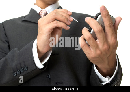 a businessman uses an electronic organiser Stock Photo
