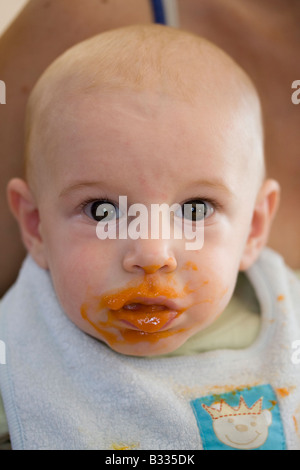 baby eats carrot mash Stock Photo