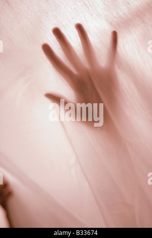 woman's hand behind curtain Stock Photo