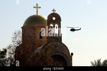 A Russian Orthodox Church by the side of the River Jordan in Israel, a Jordanian security helicopter circling in the background. Stock Photo