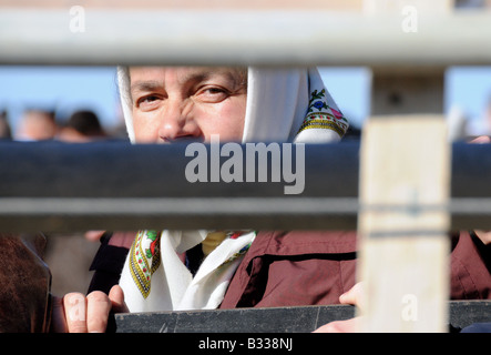 A Greek Orthodox Chrisitan pilgrim waits behind barricading for an annual mass-Baptism ceremony in the River Jordan. Stock Photo