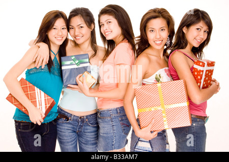 Five pretty asian women holding gifts and presents Stock Photo