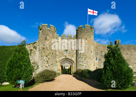 Amberley Castle entrance gate in spring, flying England flag of Saint George, West Sussex England UK Stock Photo