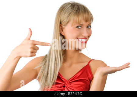 beautiful and smiling woman in red dress presenting a virtual product on white Stock Photo