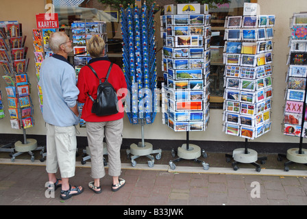 tourists choosing postcard from a shop display in Holland Stock Photo