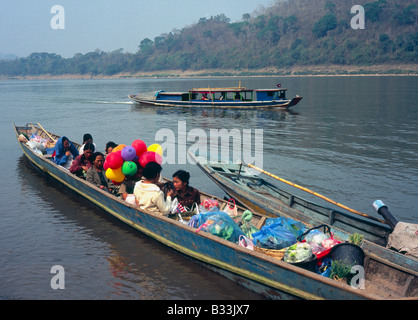 Laos Luang Prabang Mekong river public transport people waiting in small boat to get back to village along river Stock Photo