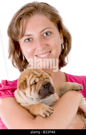 Happy owner of a baby Shar Pei dog, almost one month old Stock Photo