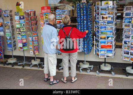 tourists choosing postcard from a shop display in Holland Stock Photo