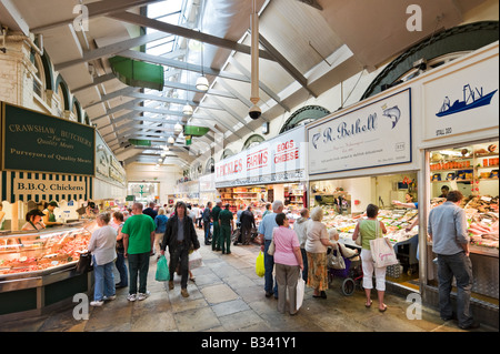 Food Stalls in the Edwardian Kirkgate Market, Leeds, West Yorkshire, England with a CCTV camer in the foreground