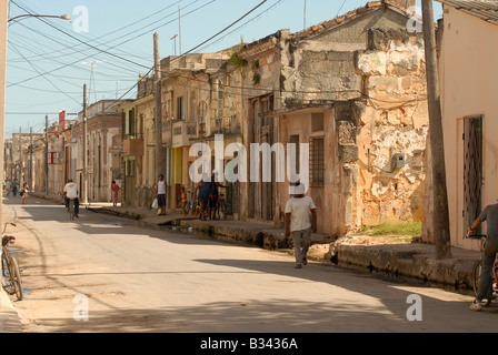typical street scene in Cardenas Matanzas Province Cuba showing derelict buildings and Cuban people Stock Photo