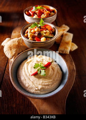 Party Food - From Front - Houmous, [chick pea] salad, marinated Mediterranean roast peppers Stock Photo