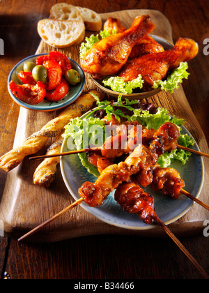 BBQ food - From Front - Chicken Yakitori, Marinaded chicken drum sticks and sun blushed tomatoes. Stock Photo