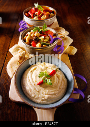 Party Food - From Front - Houmous, chick pea salad, marinated Mediterranean roast peppers Stock Photo