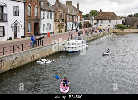 A view of the Quay from St Ives Bridge, two girls canoeing up the river Ouse Stock Photo