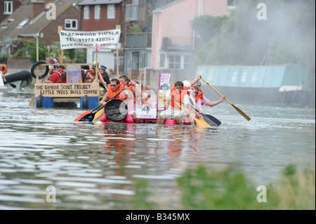 Lewes Raft Race 2008: competitors race down the river on the falling tide from Lewes to Newhaven on home made craft. Stock Photo