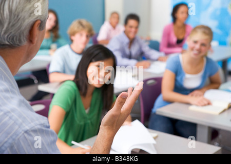 Students studying in geography class with teacher Stock Photo