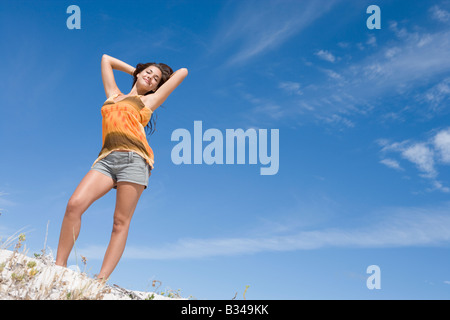 Young woman posing on a sand hill Stock Photo