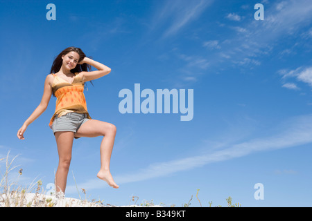 Young woman posing on a sand hill Stock Photo