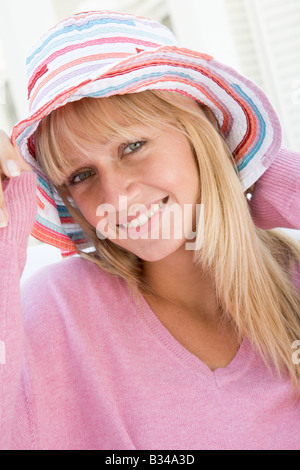 Blonde woman in a pink sweater posing outdoors Stock Photo