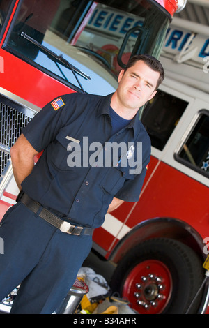 Fireman standing in front of fire engines Stock Photo