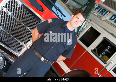 Fireman standing in front of fire engines Stock Photo