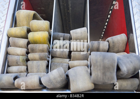 Fire hoses neatly stacked in fire engine Stock Photo