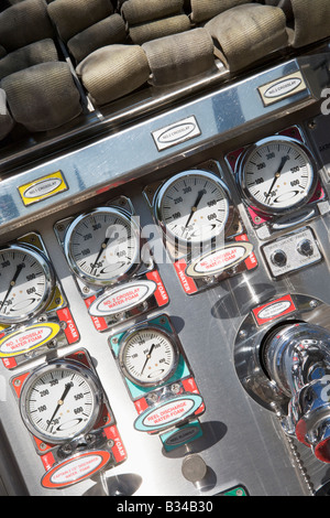 Fire hoses and pressure gauges in fire engine Stock Photo