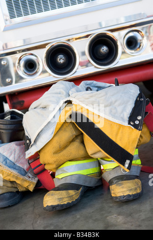 Firefighting uniforms in front of a fire engine Stock Photo
