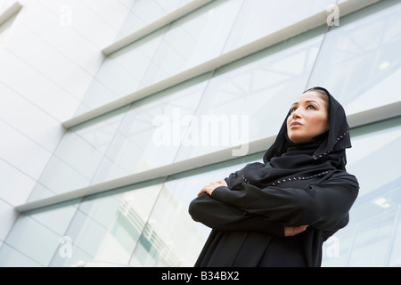 Businesswoman standing outdoors by building (selective focus) Stock Photo