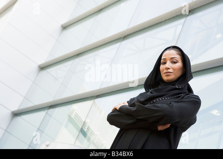 Businesswoman standing outdoors by building (selective focus) Stock Photo