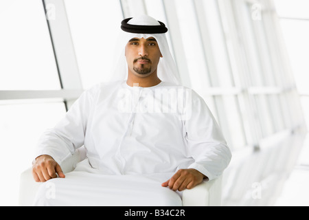Man sitting indoors (high key/selective focus) Stock Photo