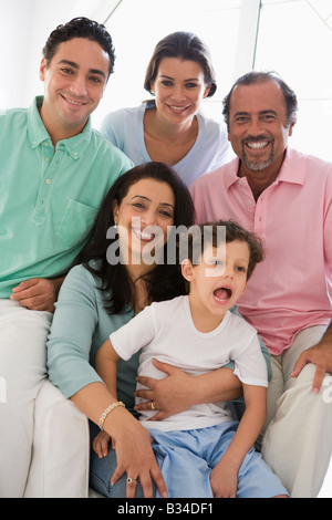 Family sitting in living room smiling (high key) Stock Photo