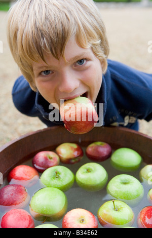 Young boy bobbing for apples Stock Photo