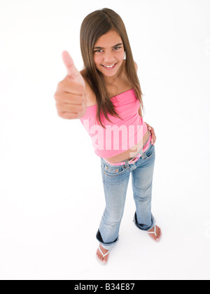 Young girl giving thumbs up smiling Stock Photo