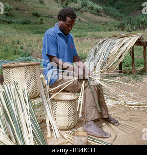 Uganda, Southwest Uganda, Muko. Most women in Southwest Uganda carry their farm produce to market in attractive split-bamboo baskets balanced on their heads. The baskets are made exclusively by men. Stock Photo