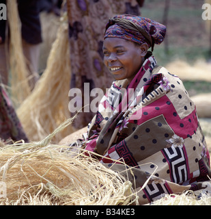 Uganda, Kisoro, Lake Mutanda. The twice-weekly market at Kisoro is a hive of activity with women selling their farm produce to traders from all over Uganda.This woman is selling raffia from the prickly raffia palm, whose leaf fibres are used in basketry and weaving. Stock Photo