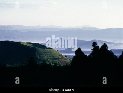 Uganda, Kisoro, Lake Mutanda. The beautiful hill-country of Southwest Uganda and Rwanda supports one of the highest human population densities in Africa. Consequently, every square inch of this fertile volcanic land is tilled and crudely terraced on steep hill slopes to prevent erosion. Blessed with good rainfall, almost every conceivable crop is grown.The evidence of recent (in geological terms) volcanic activity is everywhere. The two most westerly volcanoes of the Virunga chain are still active. Stock Photo