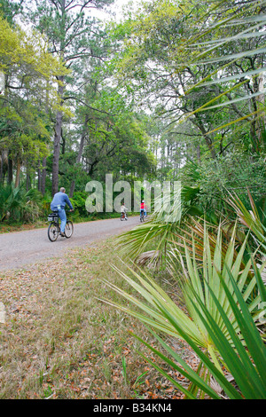 Family riding bikes on Pinckney Island National Wildlife Refuge, Hilton Head, South Carolina Stock Photo